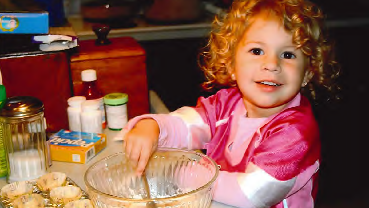 Before tragedy struck, Kilah was a joyful, energetic child who loved to help in the kitchen, always curious and full of life.