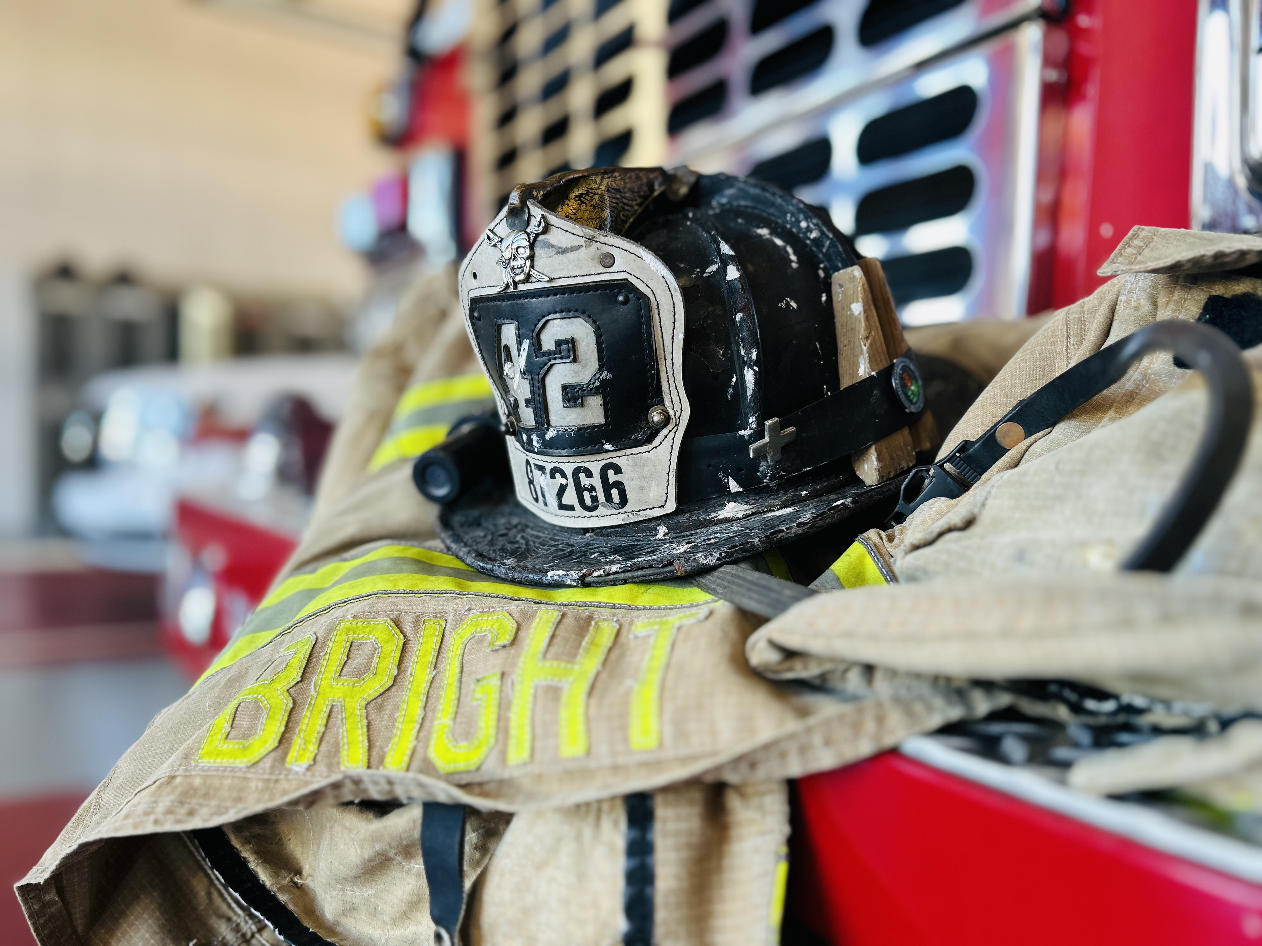 Capt. Lee Bright rests against Engine 42 inside the firehouse, a familiar setting that became a source of normalcy during an uncertain chapter of his life. 