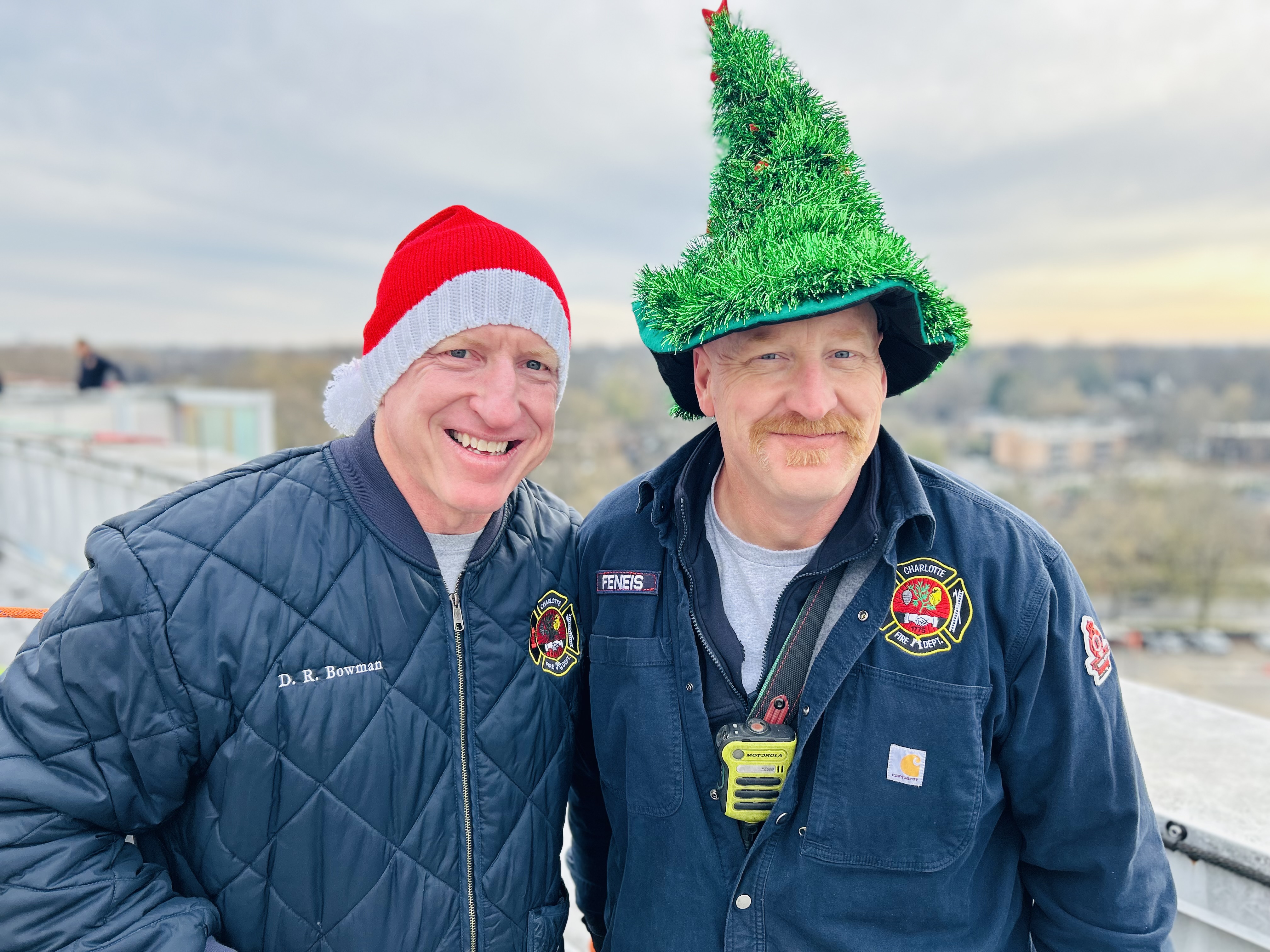 Captains David Bowman and Mike Feneis take a quick break to share a laugh on the roof of Levine Childrens before joining the day’s rappel. 