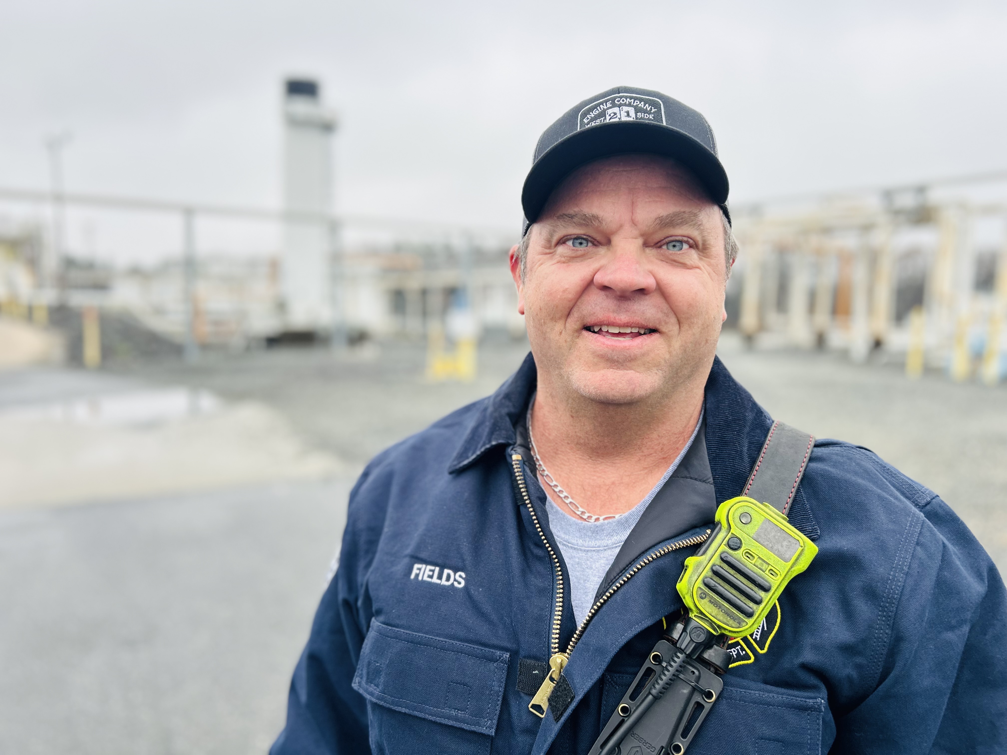 Charlotte Fire Captain Shane Fields stands at a fuel storage facility in west Charlotte during site operations.