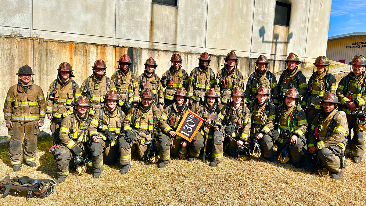 Surrounded by his fellow recruits, Nicolas Adade stands with Charlotte Fire Recruit Class 130, ready to take on the challenges of the fire service.