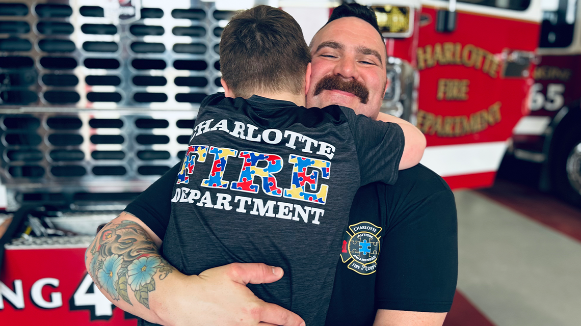 Nate Powell holds his son, Benjamin, in a tight hug inside Firehouse 42