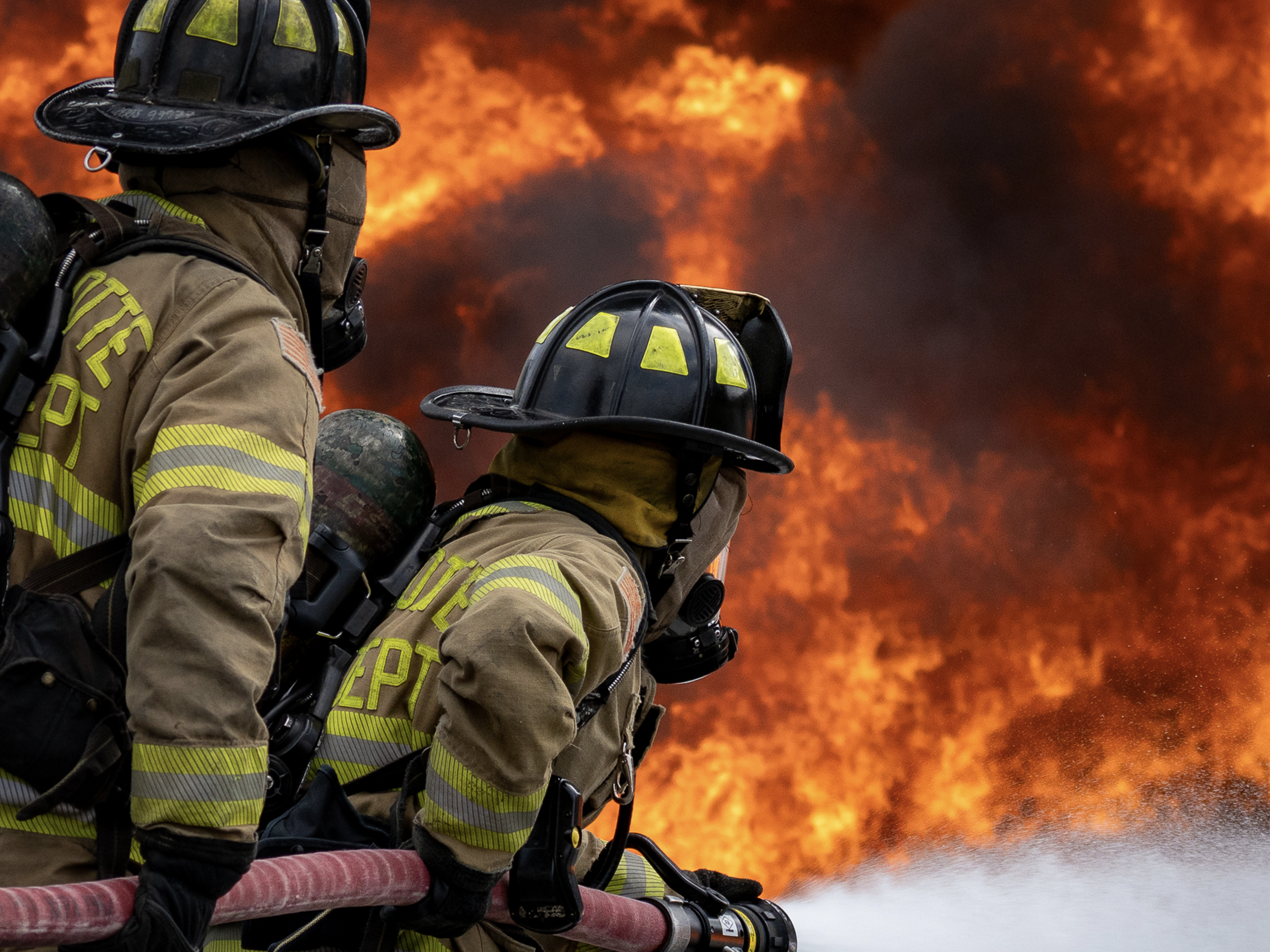 Charlotte Firefighters face down flames during training, a reminder of the dangers on the job beyond cancer-causing exposures. 