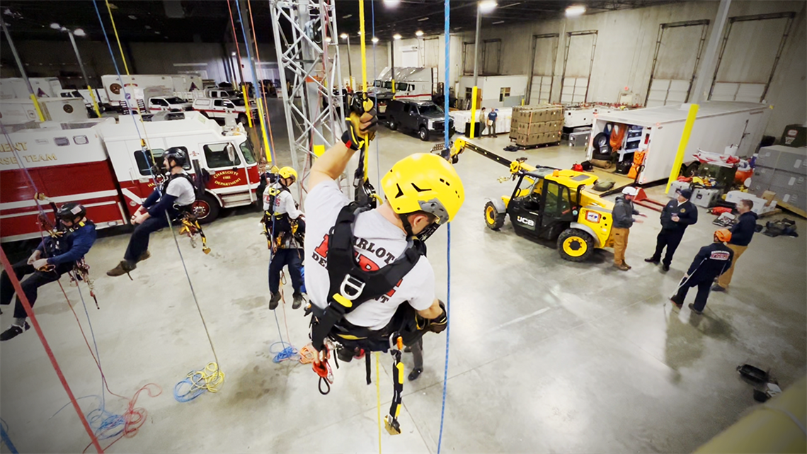 Firefighters maneuver through an advanced rope system inside the Charlotte Fire Special Operations Complex, sharpening their life-saving rescue techniques. 