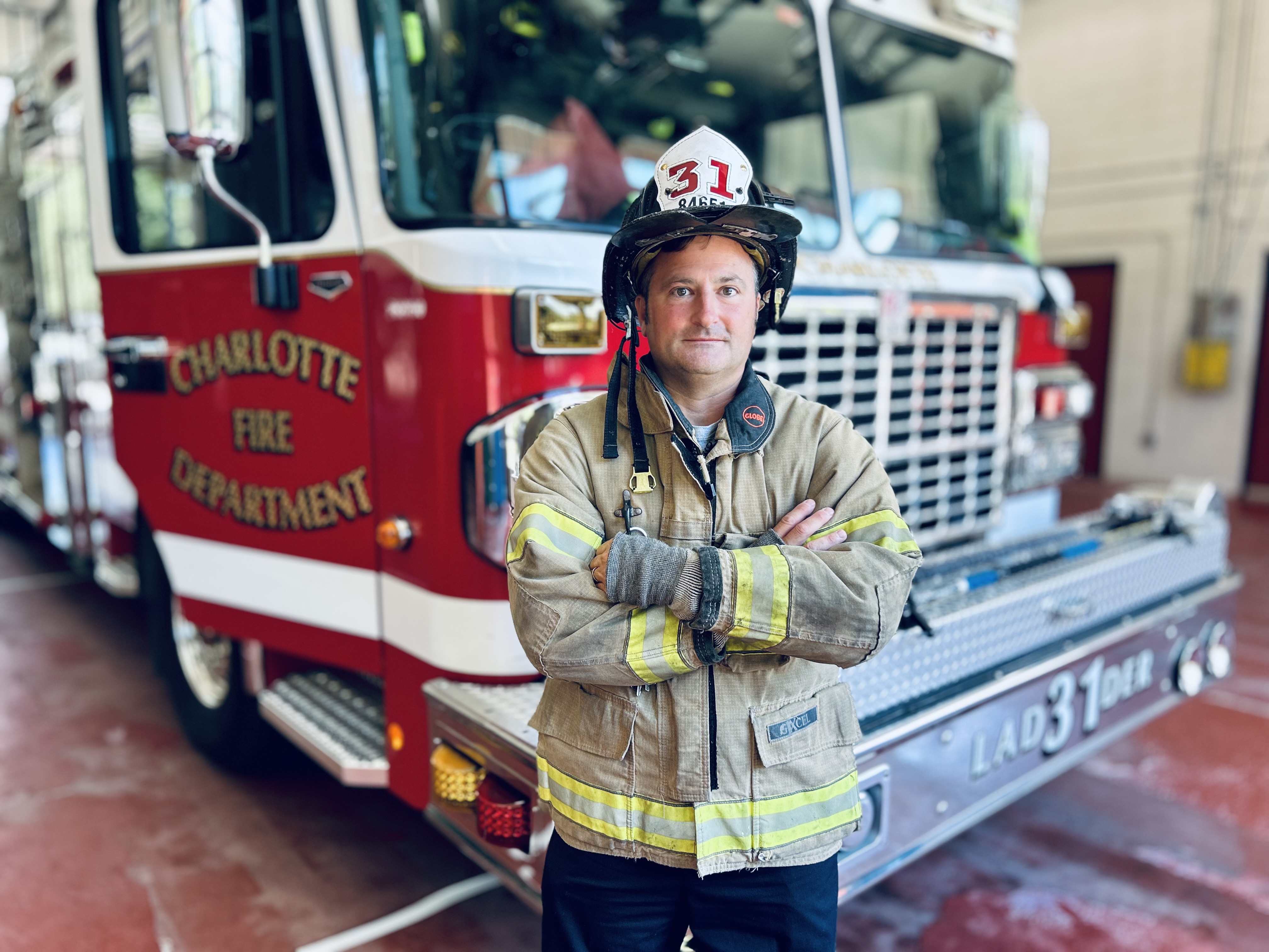 In full gear before Ladder 31, Capt. Harwell stands ready for the job he loves, a reminder that cancer did not take him away from his calling.