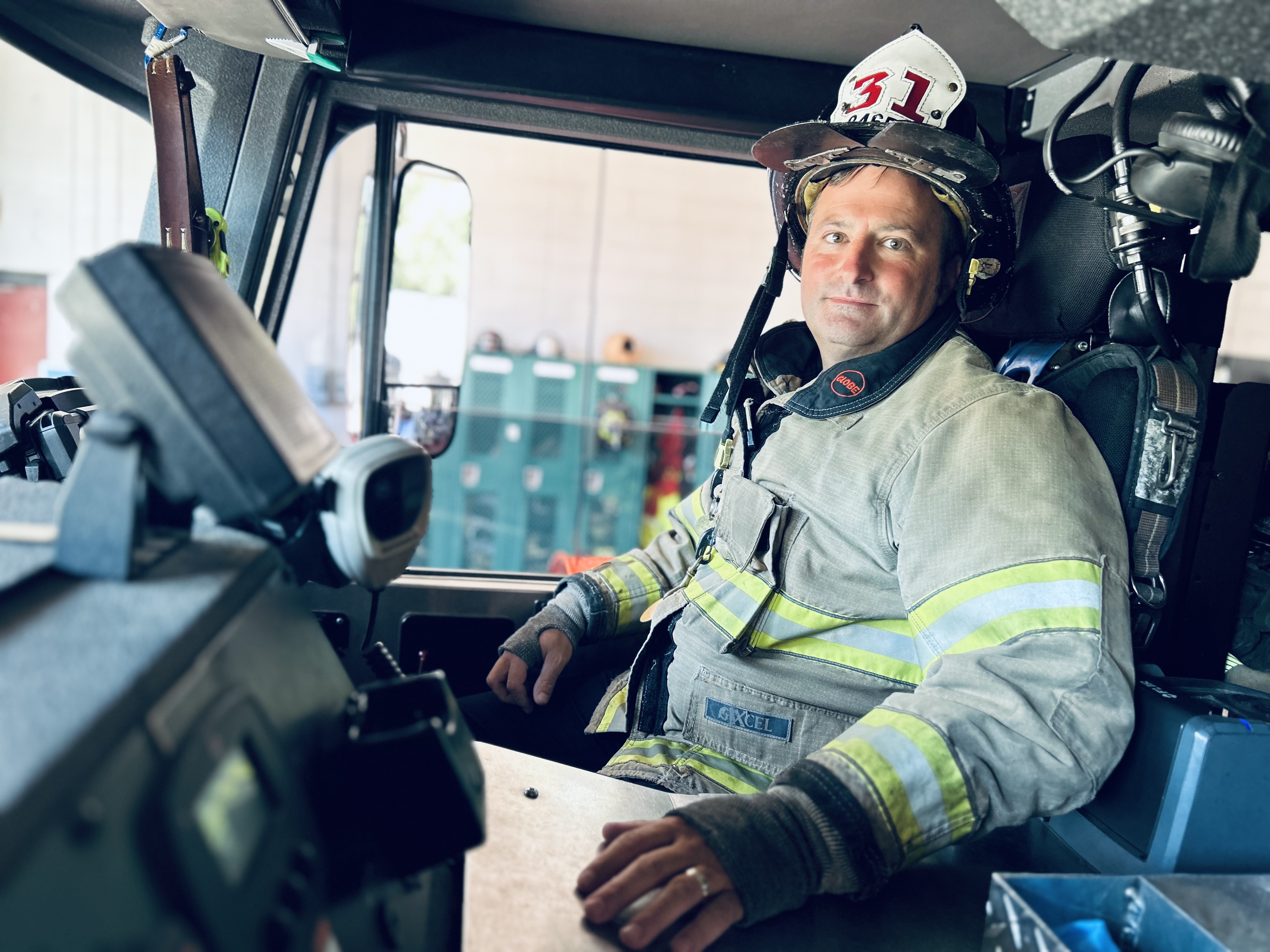 Capt. Harwell sits in the cab of Ladder 31, where countless emergencies have been answered, holding onto the sense of purpose that guided him through recovery.