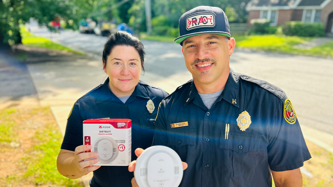 With smoke alarms in hand, Firefighter Bennett and Captain Hutchison of Engine 15 support Charlotte Fire’s mission to protect homes through education and early detection.