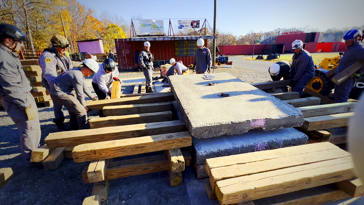 Participants combine teamwork and precision to stabilize and lift concrete slabs during the structural collapse training. This exercise emphasizes critical rescue skills necessary for saving lives in hazardous conditions.