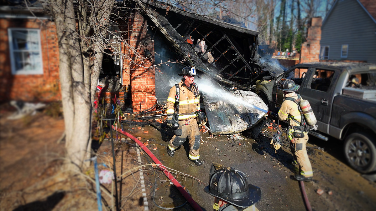 Charlotte Fire crews tackle a garage fire at a home on Harris Ridge Drive. Their swift actions helped limit the damage and ensured the safety of the displaced family.