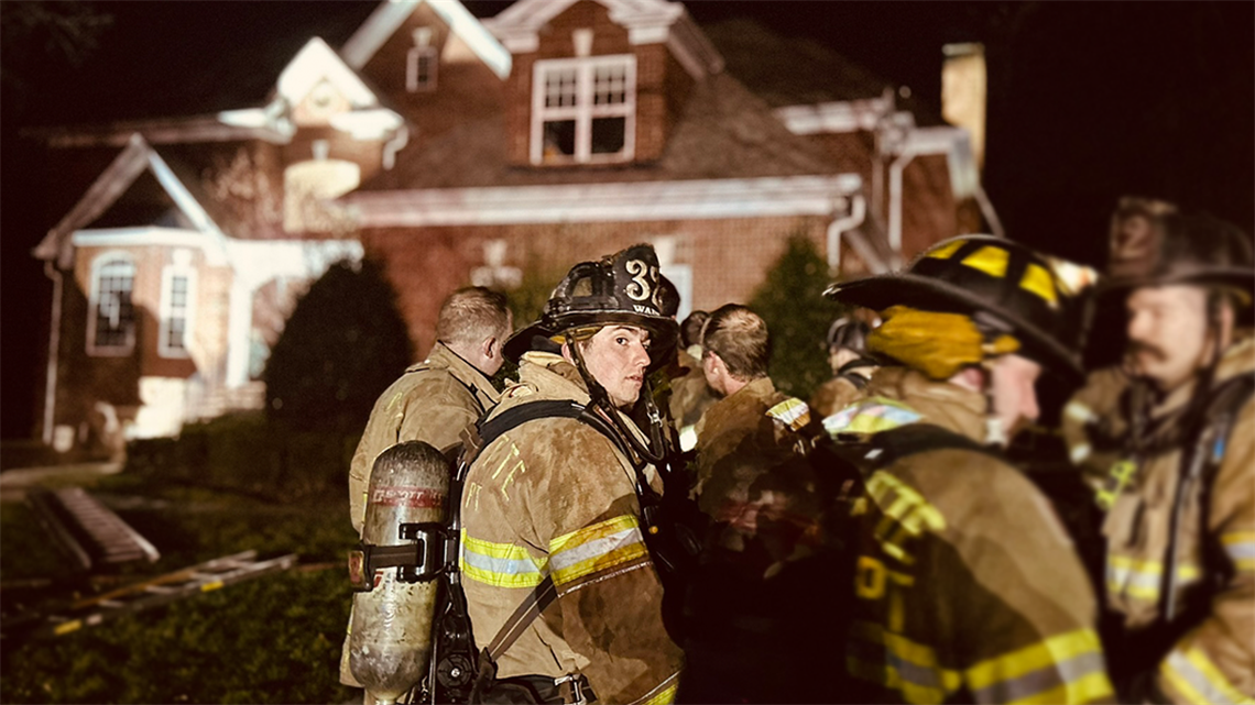 Firefighter Brandon Wade from Engine 32 takes a moment after battling the two-alarm chimney fire on Callander Court. Charlotte Fire crews worked late into the night to ensure the fire was fully extinguished and the scene was safe. 