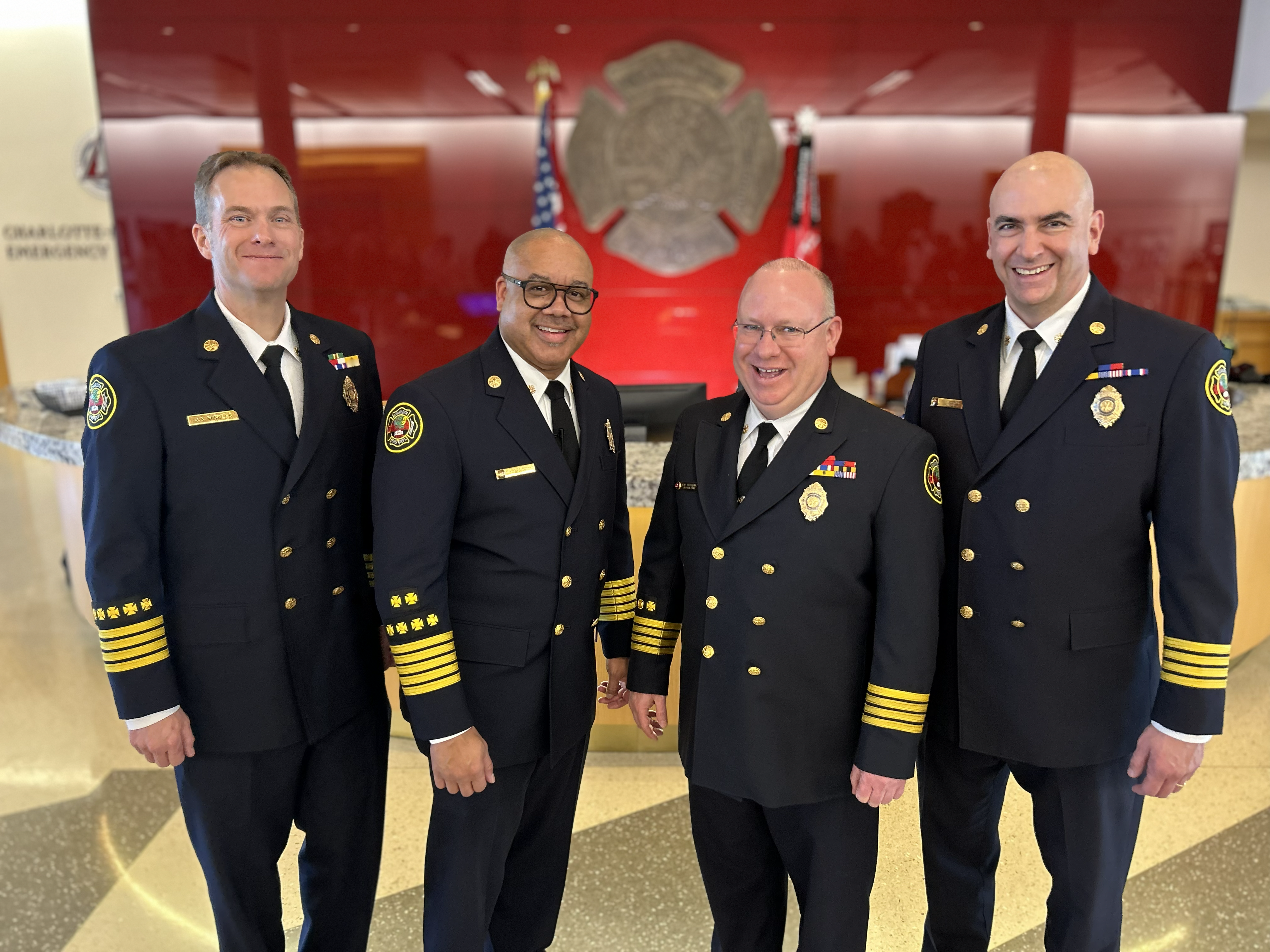  Deputy Chief Winkles, Fire Chief Reginald Johnson, Deputy Chief Wike Graham, and Deputy Chief Fitzgerald stand at Charlotte Fire headquarters following Graham’s promotion. 