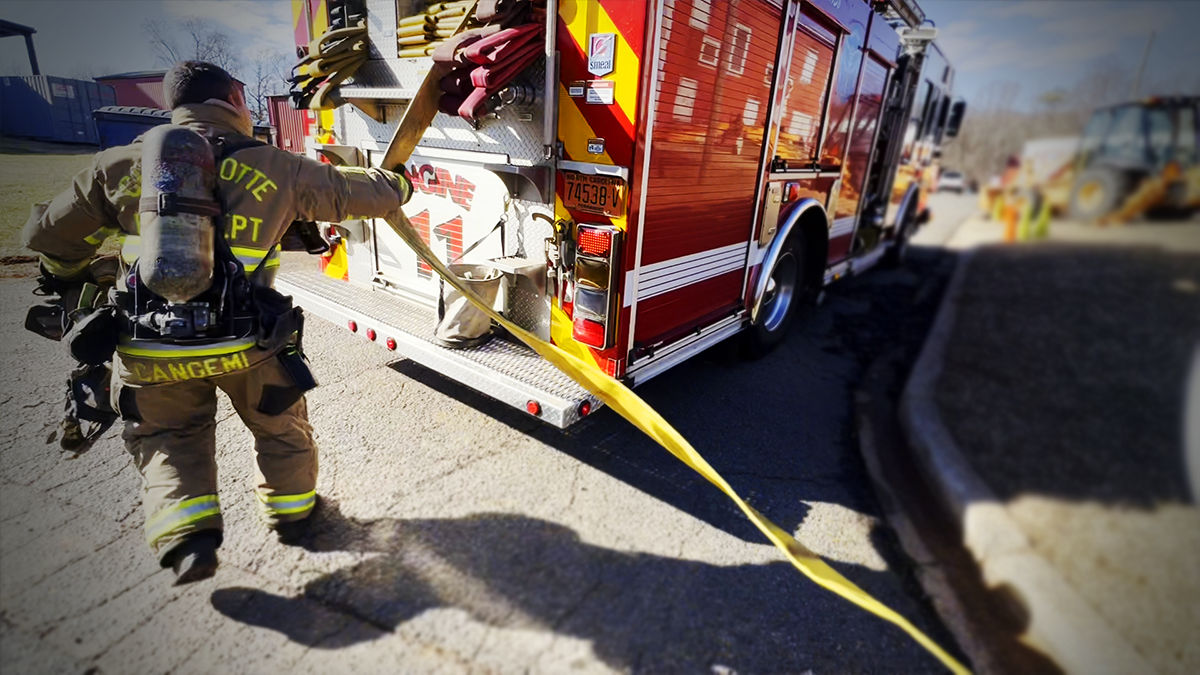Firefighter Cangemi from Engine 11 pulls a dry line into position during winter training exercises. 