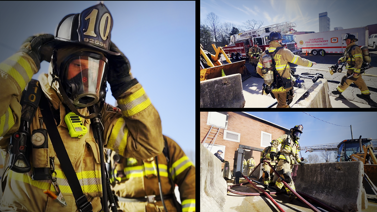 Firefighters prepare to enter a smoke-filled training building, working together to execute a simulated search-and-rescue operation. 