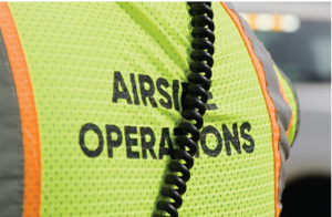 Employee safety vest with partially covered text:'AIRSIDE OPERATIONS'