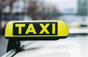 Taxi sign above vehicle