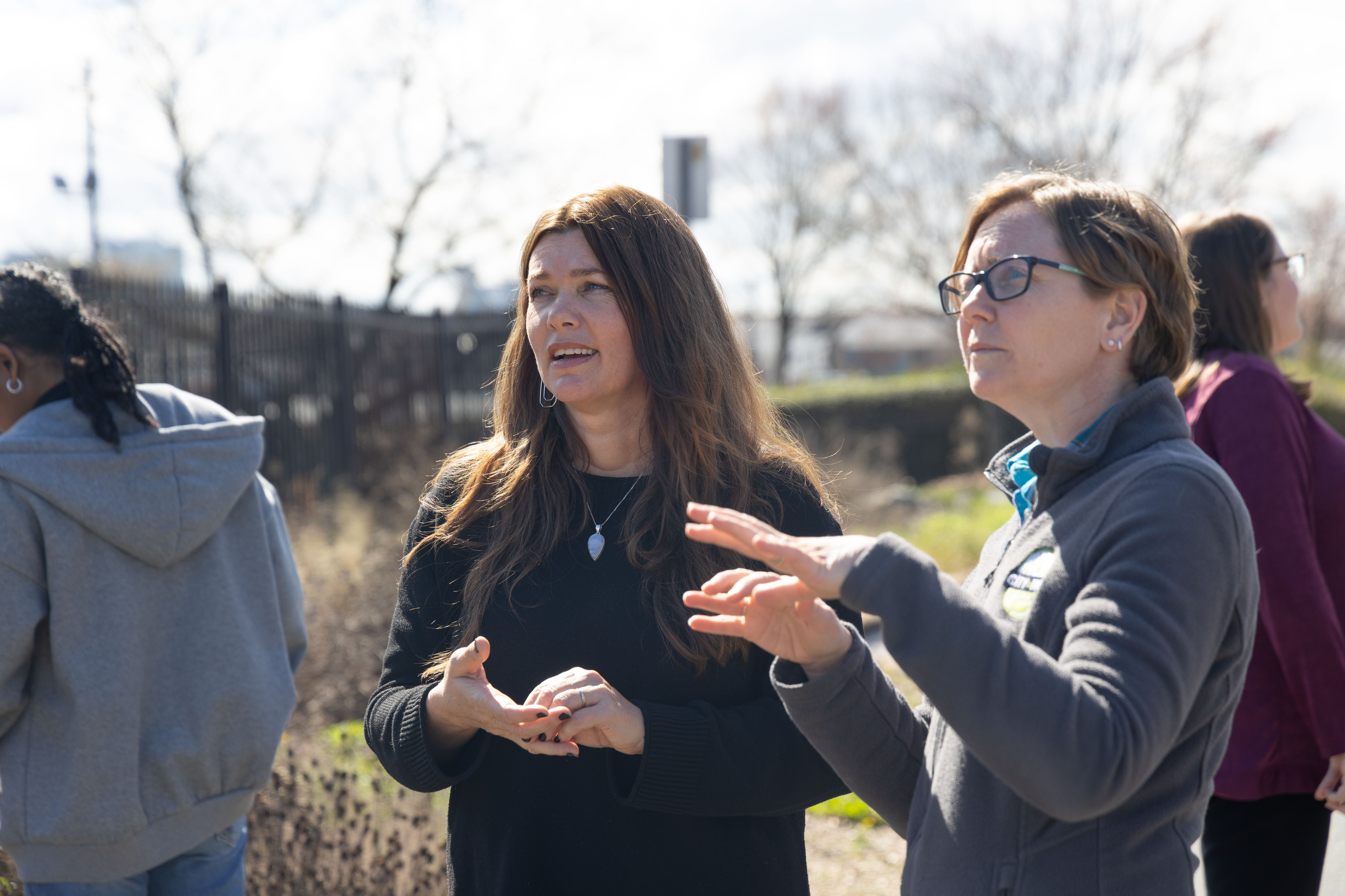 Victoria Aguilar (left) and Laurie Reid (right) talk through options for maintaining a tree on the property.