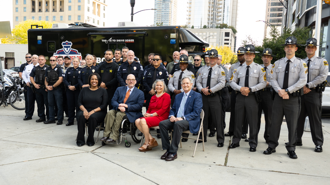 Officers, the Charlotte mayor, and state officials sitting together
