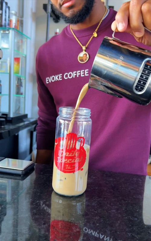 Evoke Coffee employee pouring drink