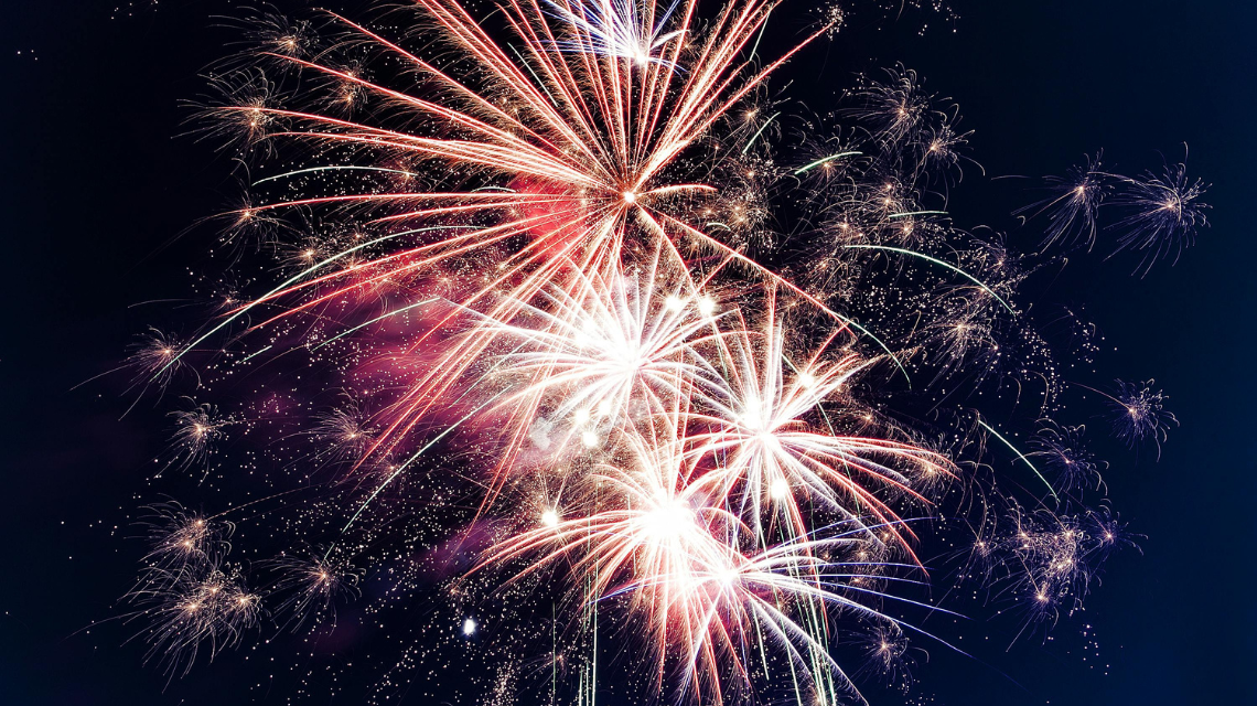 Fireworks exploding in the night sky.