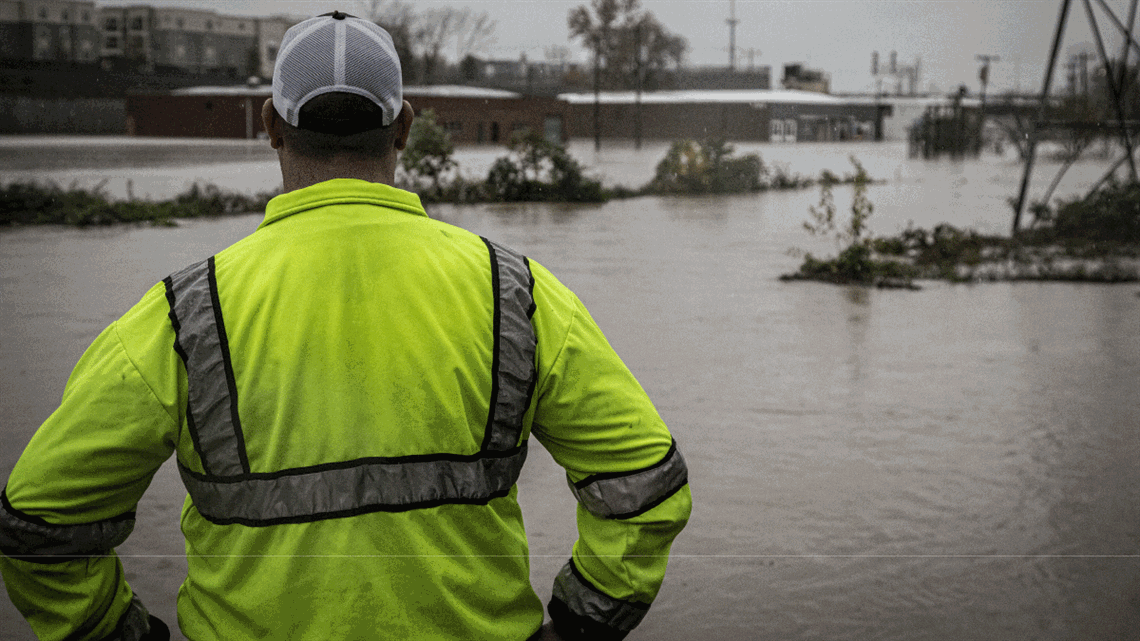 Man looking at flooded area