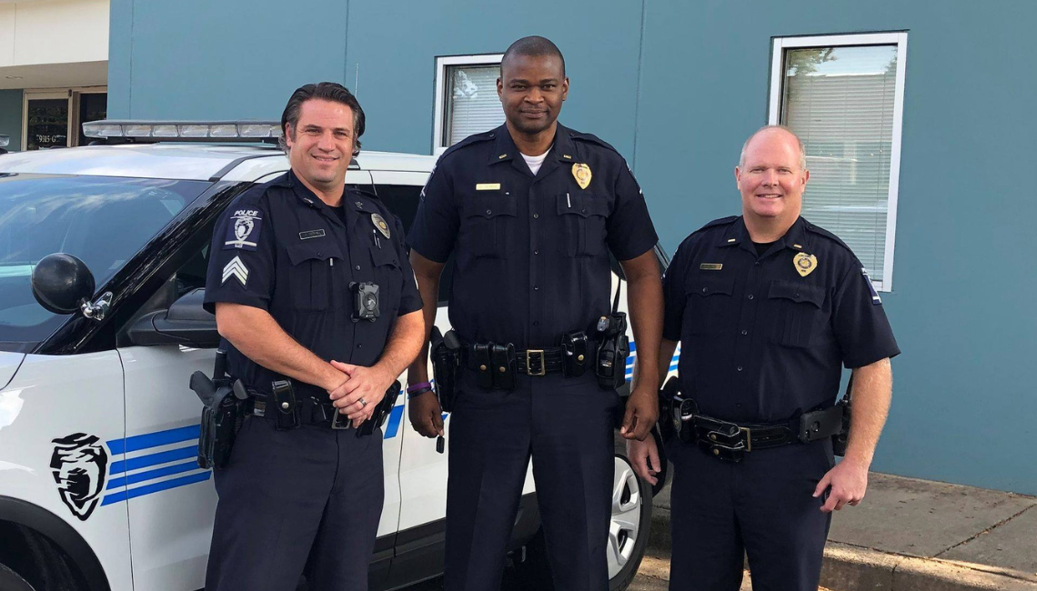 Iyevbele (middle) with two officers (Chris Decker & David Blum) after assisting a stranded driver in 2019.