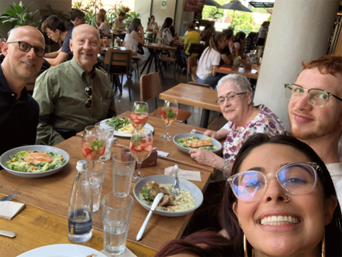 Luis with his parents & his children enjoying a meal.