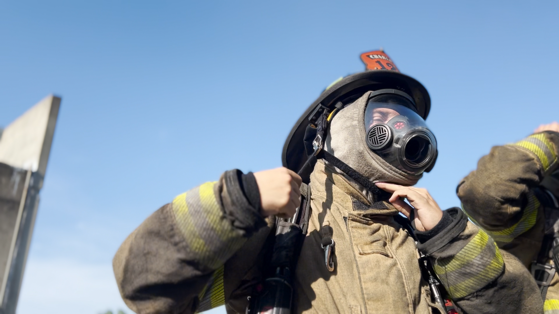 Gazerro gets ready to work with full gear and a gas mask.