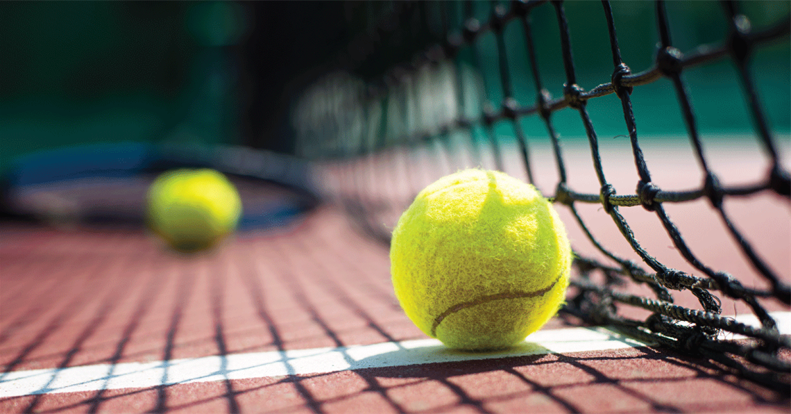 Tennis Ball on Court Near Net