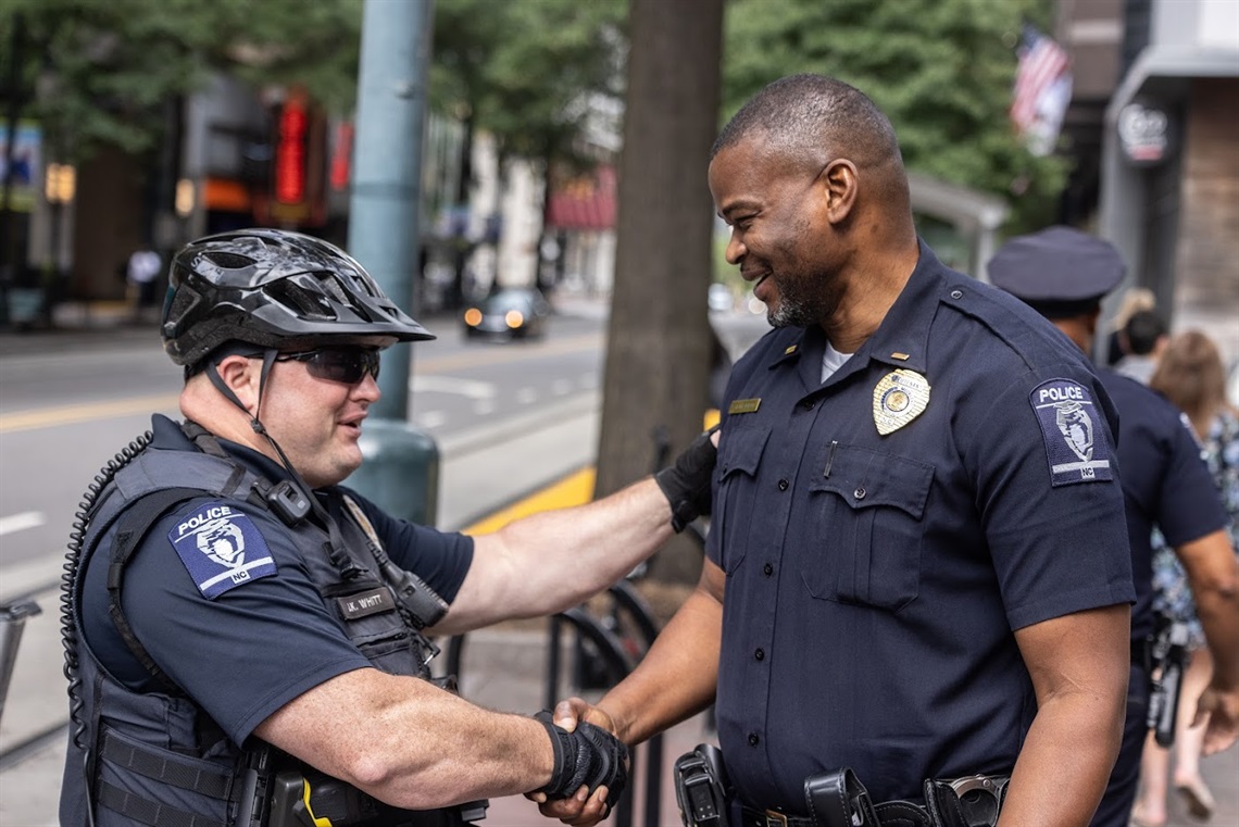 Captain Stephen Iyevbele (right) shaking the hand of fellow officer James Whitt.