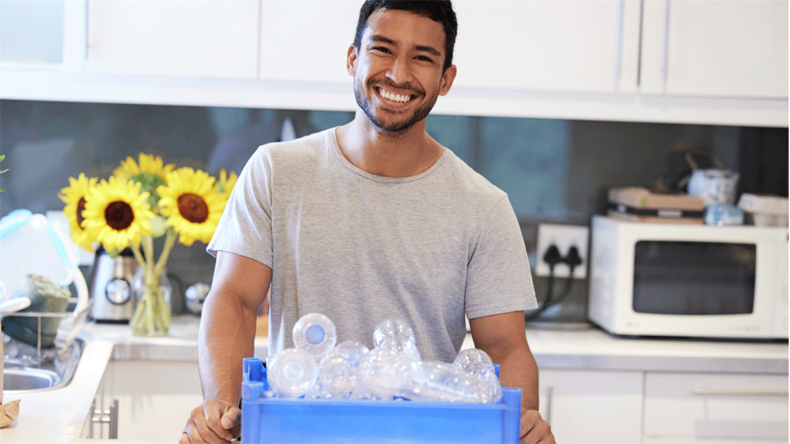 Man preparing to recycle some plastic bottles at home.
