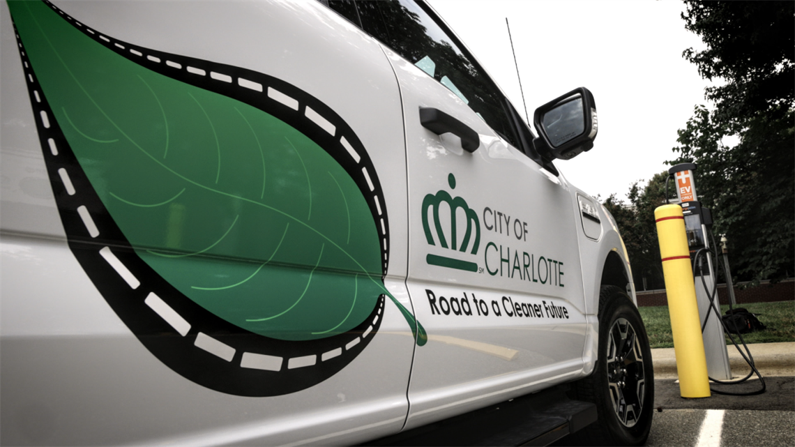 Close up of City of Charlotte electric vehicle decal that reads, 'Road to a Cleaner Future'.