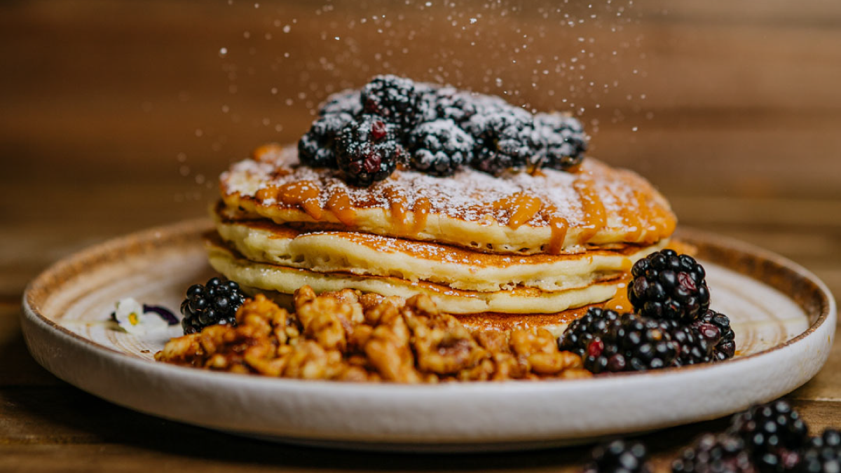 El Puro’s Tres Leches Pancakes with fresh fruit and candied walnuts.