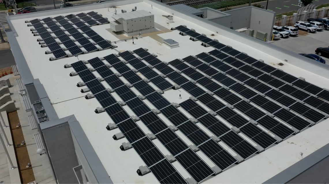 Solar panels arranged on the roof of a CMPD building.