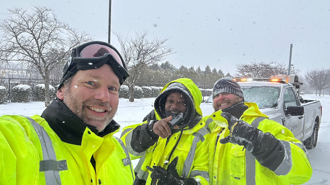 Three CATS employees pose for a photo during the winter storm and smile at the camera.