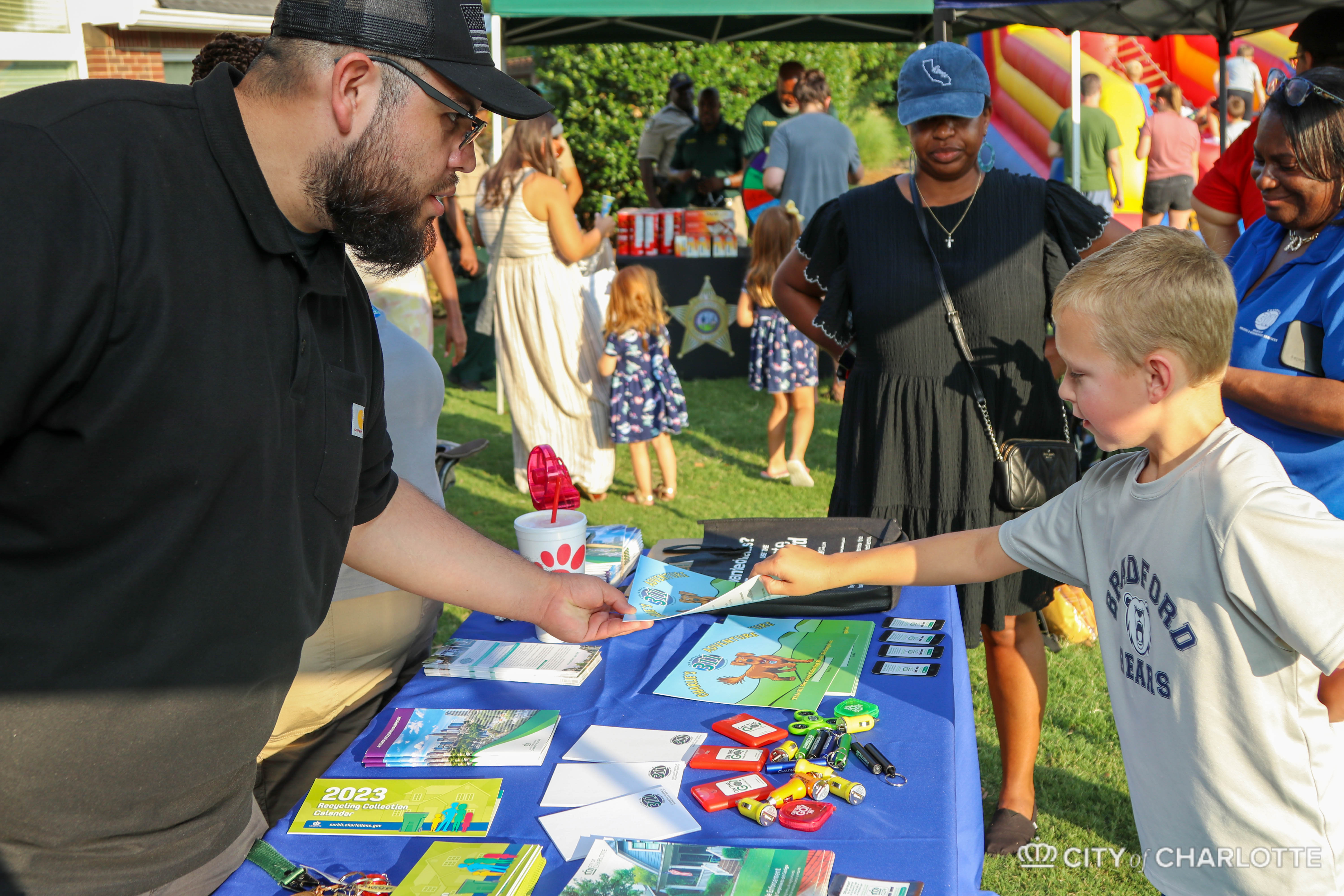 child at table receiving handouts
