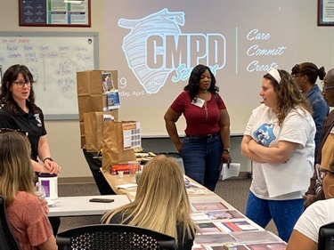 Ladies standing around table in image from Civic Leadership Academy Session