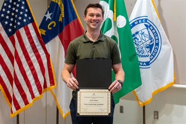 Image of man holding CLA certificate from Civic Leadership Academy Session