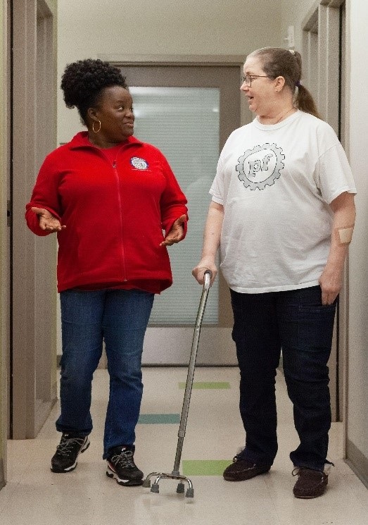 Two women walking and speaking.