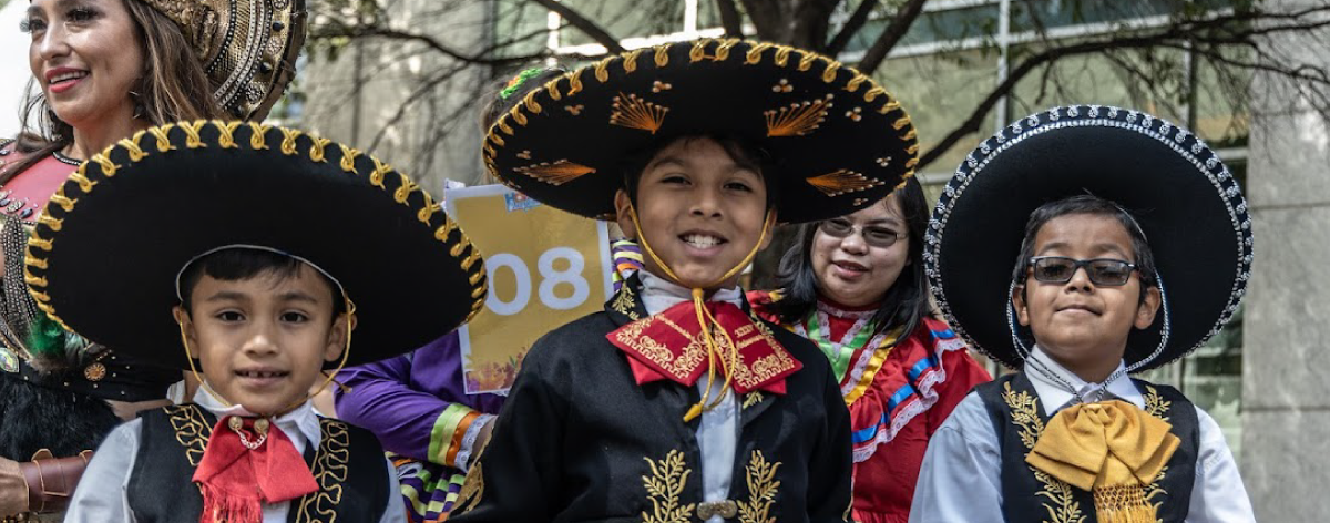 Children dressed in traditional Mariachi outfits and folklore dress