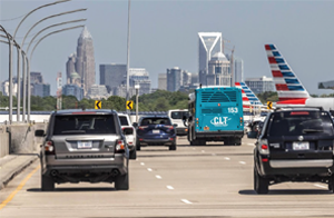 Highway view of vehicles heading toward Uptown Charlotte
