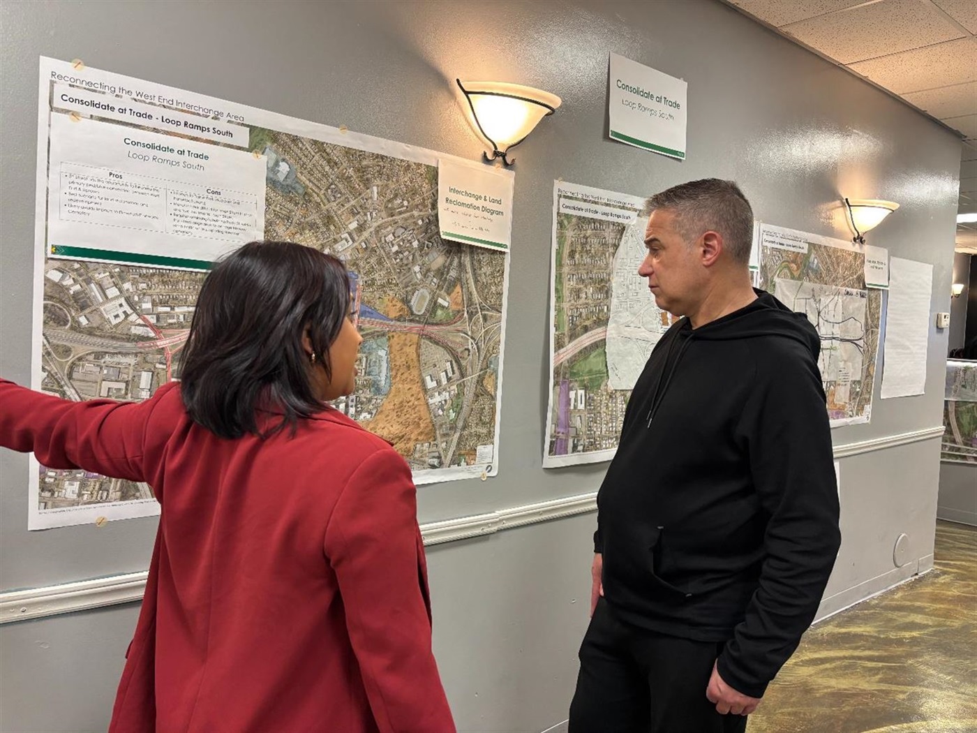 A woman walking a man through a map